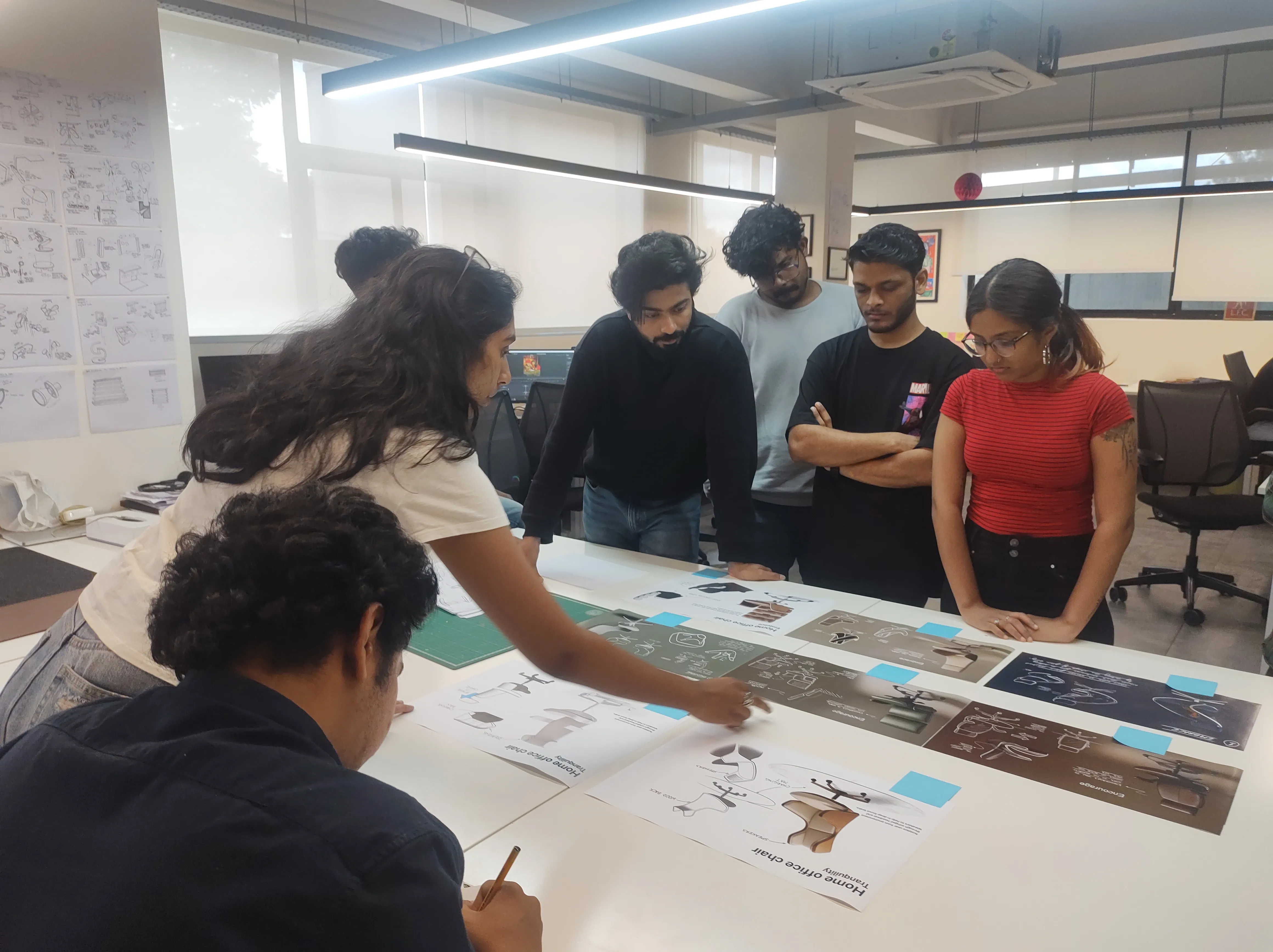 Team reviewing the printed concept boards around a table