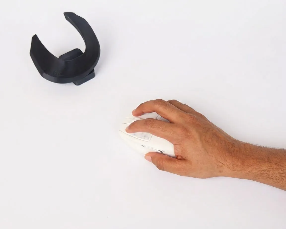 V1 prototype in hand on the desk, grip alongside
